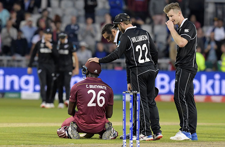 Carlos Brathwaite is consoled by Kane Williamson and Ross Taylor after getting caught on the boundary. (Getty Images)