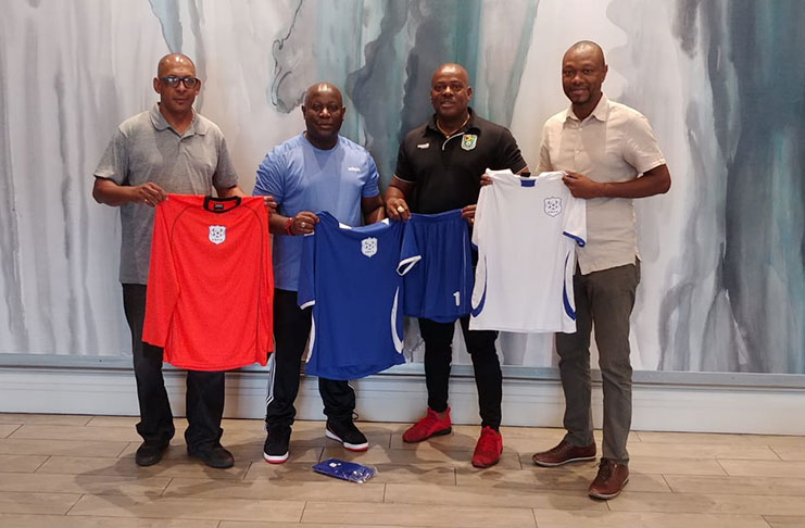 David Anglin (2nd left), EBFA president Franklin Wilson (2nd right), GFF executive member Dion Inniss (right) with responsibility for the EBFA, and Roger Murray display the new uniforms at the Kansas City Marriott Country Club Plaza.