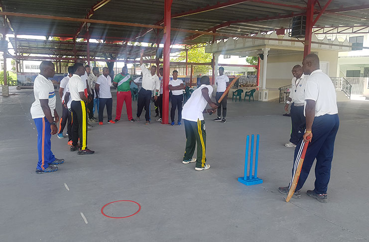 Roger Harper demonstrates a bowling point to the participants.