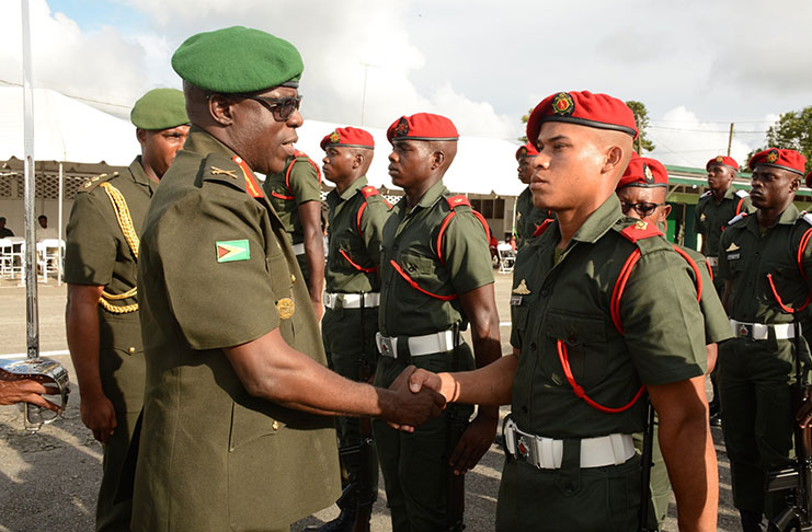 Chief of Staff Brigadier Patrick West congratulates one of the many ensigns after the parade