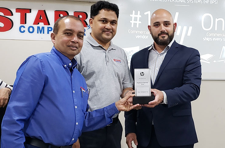 From right: HP Territory Manager, Gustavo Gurdian, presents the HP Platinum Plaque to STARR Computer President, Mike Mohan, and General Manager, Rehman Majeed, for the company’s outstanding performance