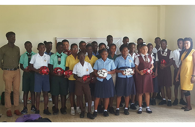 The various schools that will be participating in the ExxonMobil U-14 schools football tournament were handed balls for their preparation.