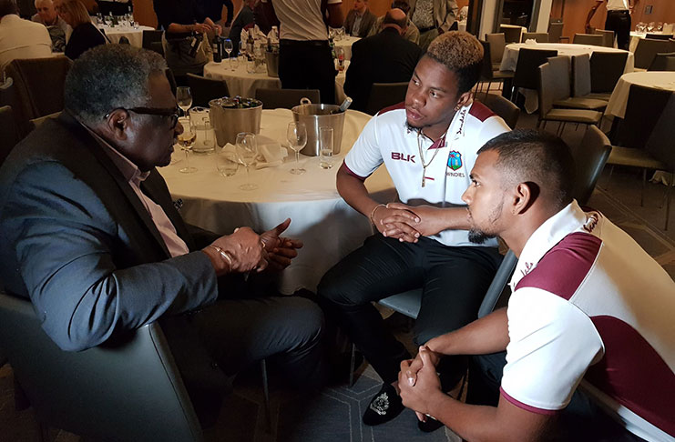 Former West Indies captain Clive Lloyd speaks to current batsmen Nicholas Pooran, right, and Shimron Hetmyer during a function, hosted by Sandals International at the Principal Hotel in Manchester on Tuesday night.