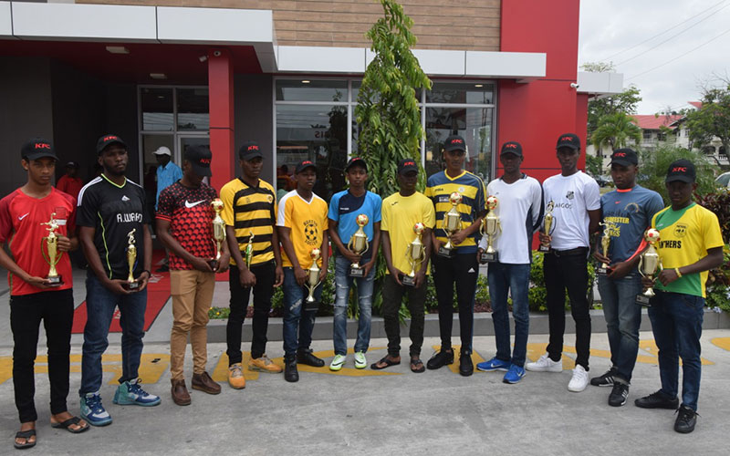 The respective captains of the various winners of the Intra-Association competitions pose with their trophies at the KFC Vlissengen Road outlet.