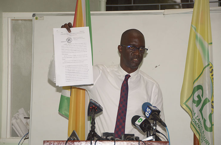 CEO of the GLSC, Trevor Benn, shows the court order which was issued back in the 1990s (Adrian Narine photo)