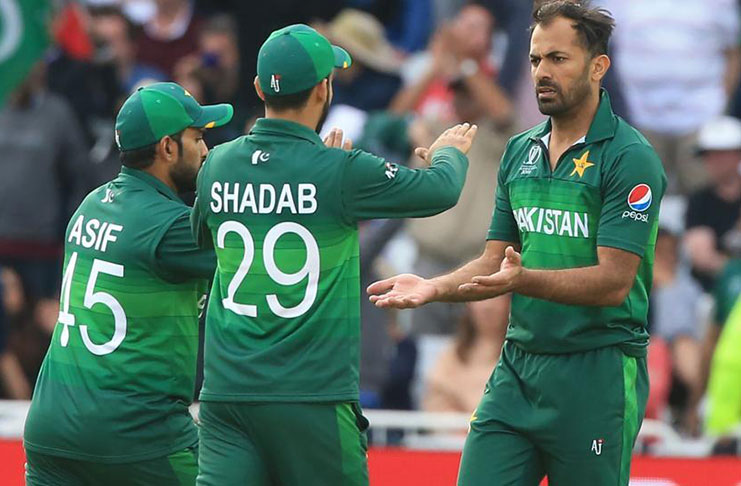 Pakistan's pacer  Wahab Riaz (R) celebrates with teammates after taking the wicket of England's Chris Woakes.(AFP)