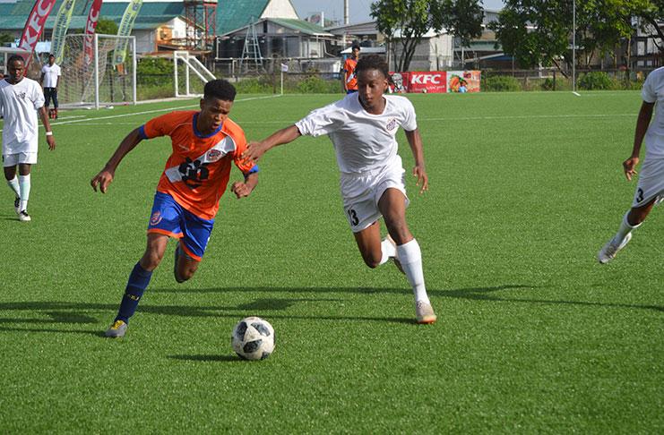 Action between Santos FC (white) and Fruta Conquerors in their GFF/KFC U-20 Independence Cup semi-final encounter, at the NTC, Providence. (Adrian Narine photo)