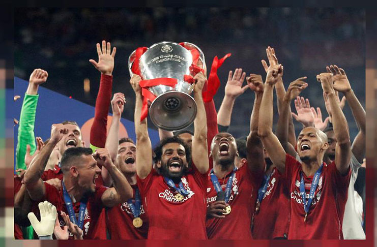 Liverpool's Mohamed Salah celebrates with the trophy and teammates after winning the Champions League Final vs Tottenham Hotspur at Wanda Metropolitano, Madrid, Spain, yesterday. (REUTERS/Carl Recine)
