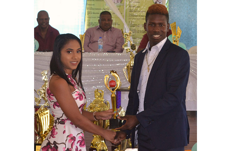 Kevin Sinclair receives his award for the  Under -19, 3-day player-of-the-year from nurse of the Port Mourant Hospital, Ms Somaroo, at the 2019 Berbice Cricket Board Brian Ramphal awards ceremony.