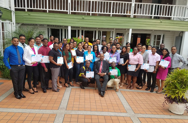 Participants, flanked by President of the Insurance Institute of Guyana, Anil Singh and Course Coordinator, Bish Panday, display their certificates. Seated at front is Director-Insurance Operations, ACll, Dip Insurance, Karan Ramlal.