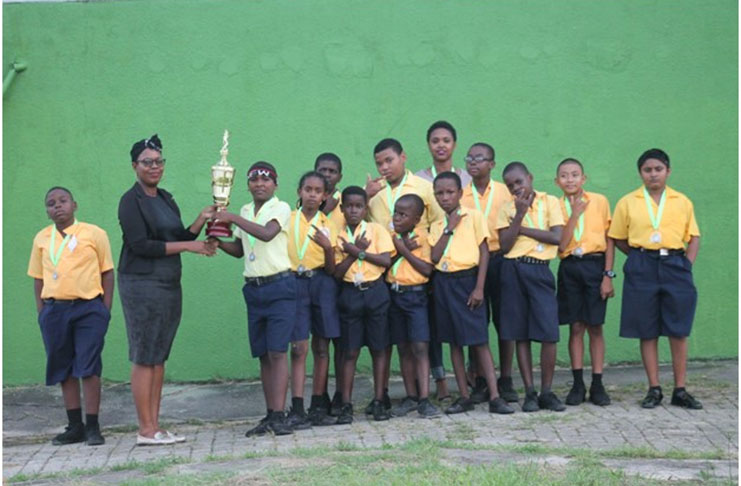 Saint Anne’s students collect the winners’ trophy.