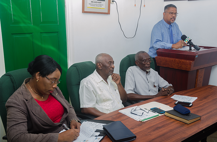 Chief Labour Officer, Charles Ogle (standing) addresses the representatives. Sitting are (from left) Head of Immigration and Support Services, Carol Lewis-Primo; Minister of Labour, Keith Scott; and Industrial Relations Consultant, Francis Carryl (Delano Williams photo)