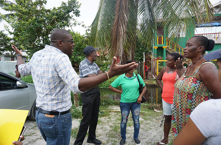 Minister David Patterson engaging some of the residents