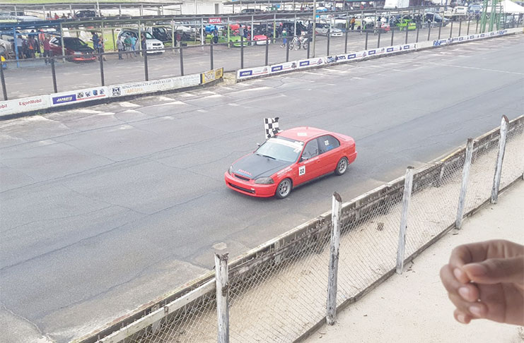 Berbician Narine Dasrat flies the chequered flag after one of his two first place finishes in his Honda Civic.