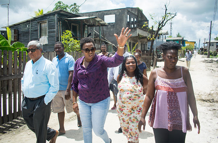 Minister Annette Ferguson and Chairman of DDL, Komal Samaroo, walk with residents during the visit to Great Diamond