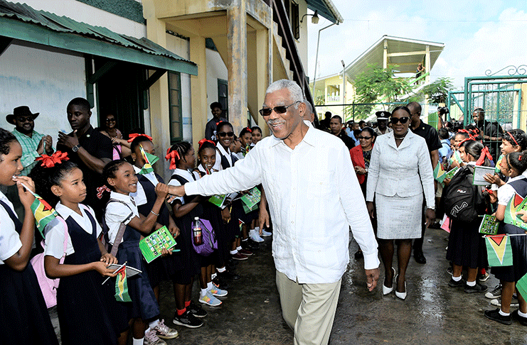 High Five! President David Granger greets students of the St. John the Baptist Primary School in
Bartica Cuyuni-Mazaruni (Region Seven). Minister of Education, Ms. Nicolette Henry follows.