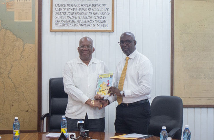 Minister of Finance, Winston Jordan receiving the Financial Intelligence Unit’s (FUI) 2018 report from FIU's Director, Matthew Langevine.