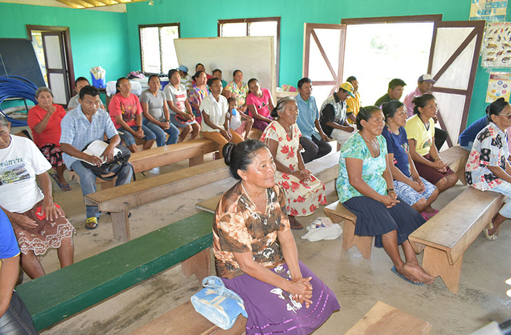 Residents of Sand Creek gather for a meeting with Guyana Water Incorporated (GWI) officials.