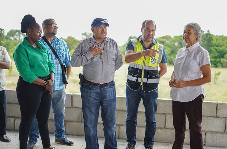 Minister of Indigenous Peoples’ Affairs, Hon. Sydney Allicock, and team listen as the contractor explains the ongoing work on the Green Enterprise Centre