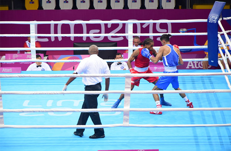 Guyana’s Kevin Allicock lands blows against Uruguayan Lucas Fernandes at 18th Pan American games in Lima, Peru.