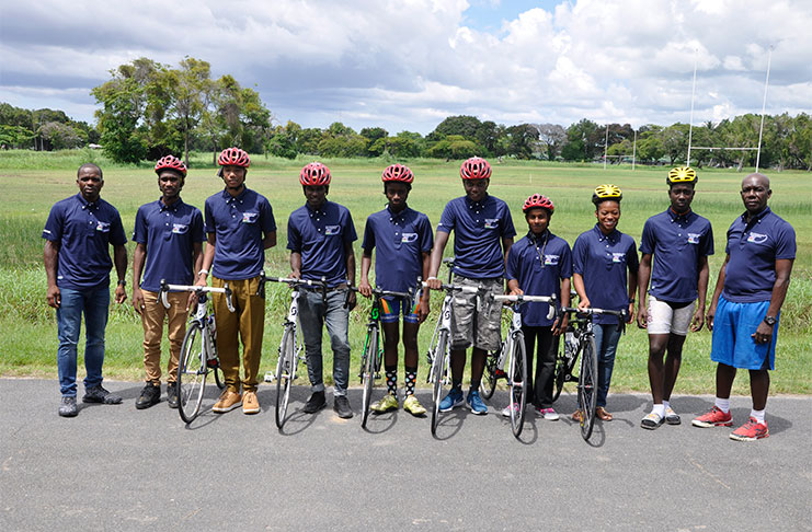 The Guyana team for the Junior Caribbean Cycling Championships posing with GCF President Horace Burrowes (left) and Assistant Racing Secretary, Joseph Britton( right) following the presentation of cycles and other equipment on Saturday last.