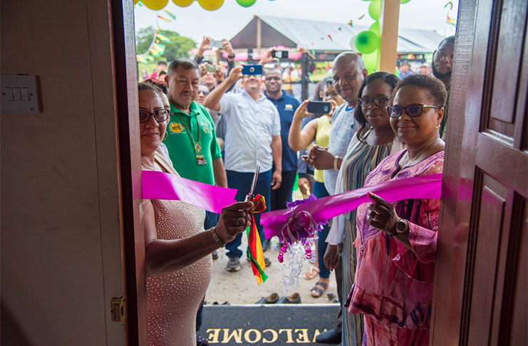 Cutting of the ribbon to officially open the waiting home. At the immediate left is one of Yvonne Jacobus’ children, while Public Health Minister Volda Lawrence and Permanent Secretary of the Ministry Colette Adams are at right, with other officials looking on Those in attendance at the commissioning ceremony External view of the maternity waiting home