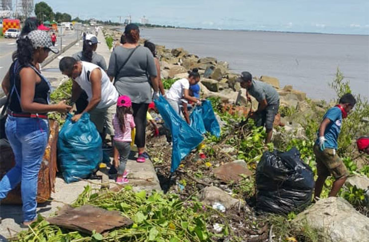 The group of Venezuelans  during the clean-up exercise at the Georgetown seawall