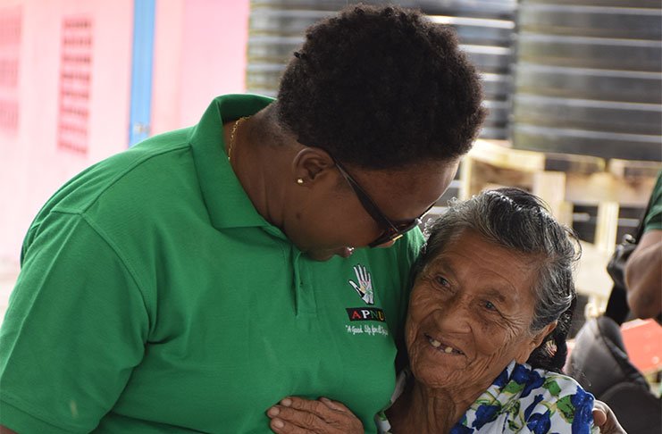 Minister within the Ministry of Communities, with responsibility for Housing, Annette Ferguson interacts with a resident (DPI photo)