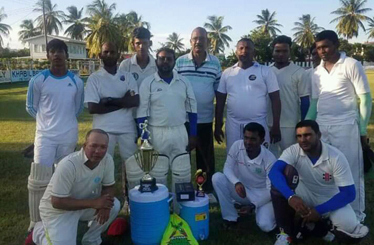 Mr. D. Somwaru poses with the winning Albion Open Cricket Team”.