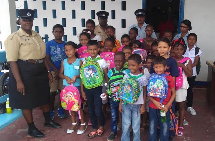 Students after receiving the haversack with supplies with police officials at the Blairmont Police Station