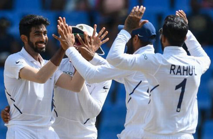 Jasprit Bumrah is swarmed by his team-mates. (Getty Images)