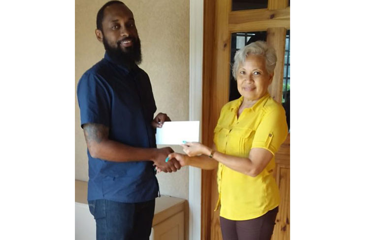 Dustani Barrow of Ibet Supreme (left) hands over his company’s contribution to GMR&SC representative, Cheryl Gonsalves.
