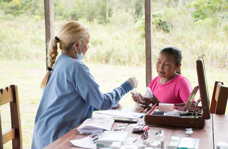 An eyecare specialist from the Cuban Medical Brigade in Guyana advises a resident of Waipa, Region Eight during a medical outreach (DPI photo)