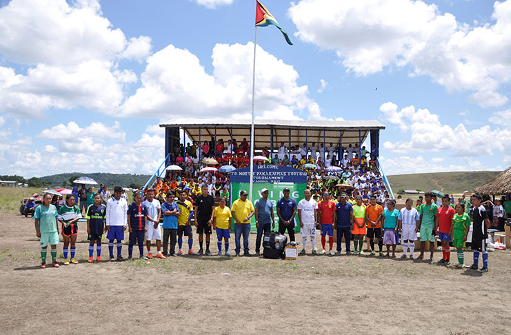 FIFA's Lenny Lake (centre) pose with representatives of the teams that received the FIFA donated equipment and other officials.