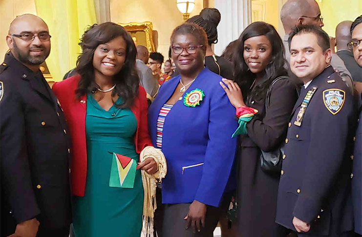 Guyanese and Haitian NYPD officers flank, from left, Haitian-American Assemblywoman, Rodneyse Bichotte; Guyanese-born New York State Senator, Roxanne Persaud and Haitian-American New York City Council member, Farah Louis (Caribbean Life)