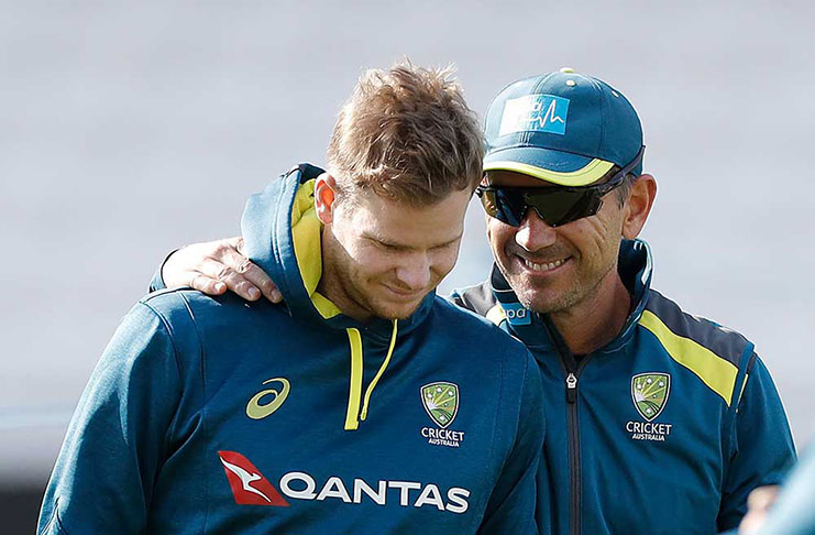 Coach Justin Langer (at right) tries to cheer up his star batsman, Steve Smith, who has scored 378 runs in three innings this series. (Getty Images)