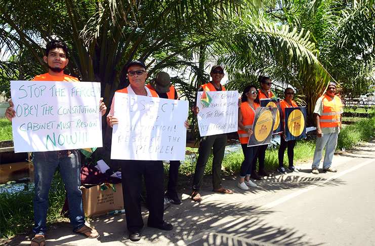 Some of the protestors with placards in front of the Ministry of the Presidency (Adrian Narine photo)