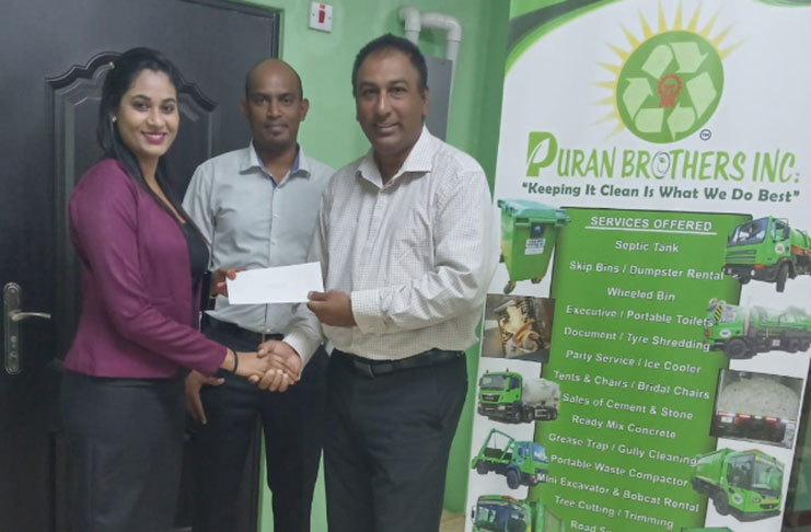 LGC president Aleem Hussain (right) collects sponsorship for this weekend’s Puran Bros Inc. inaugural golf tournament.