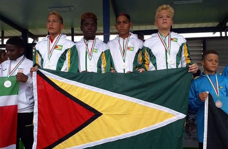 Gold medal performance: Guyana’s 4X100M medley relay team on the podium: (l-r) Vladimir Woodroffe, Jaleel Anderson, Stephen Ramkelawan and Elliott Gonsalves.
