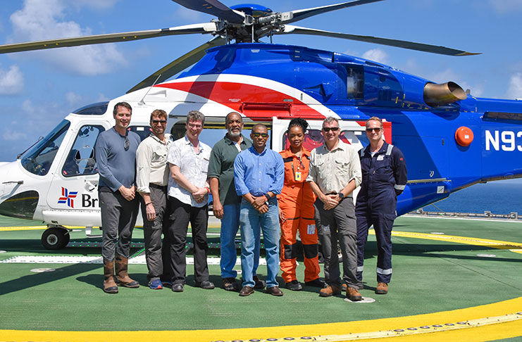 Director of the Department of Energy, Dr. Mark Bynoe (front, centre) along with British High Commissioner to Guyana, Greg Quinn; Director of the EPA, Vincent Adams; and members of the management team of Tullow Oil on the helideck of the Stena Forth