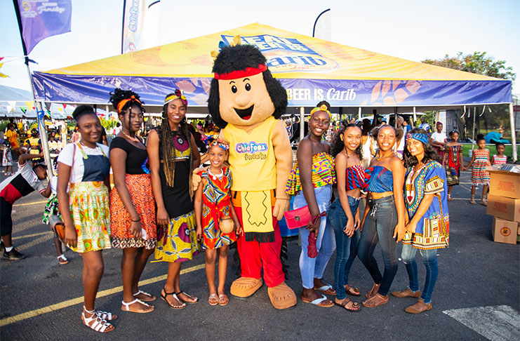 Some of the young patrons pose with the Chief Seasoning mascot at the Chief Cook Up Competition on Thursday at the Natiional Park (Samuel Maughn photo)