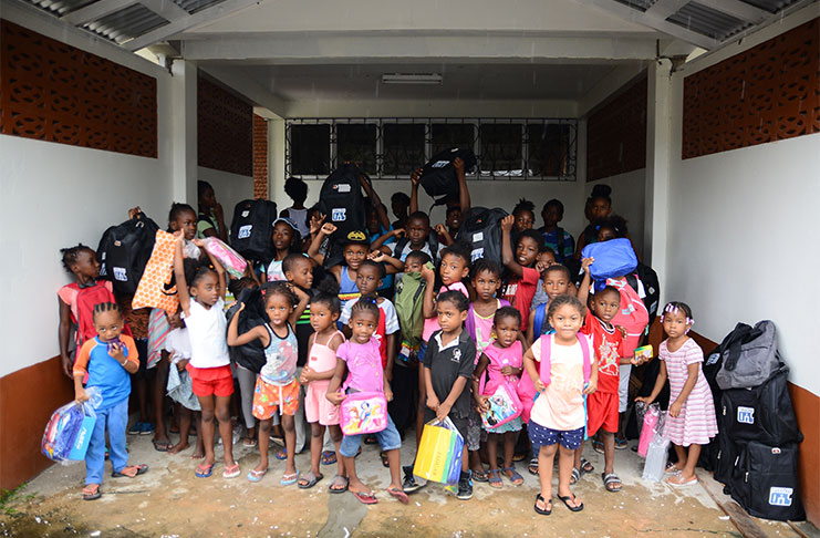 Some of the children show off the school supplies they received (Samuel Maughn photo)