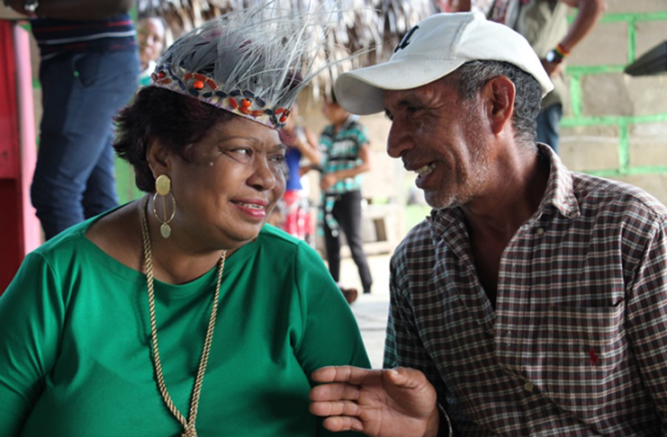 Minister of Social Protection, Amna Ally shares a light moment with a resident of Parishara