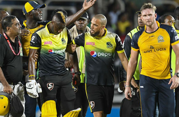 Andre Russell is dazed after a blow to the helmet. (CPL via Getty Images)