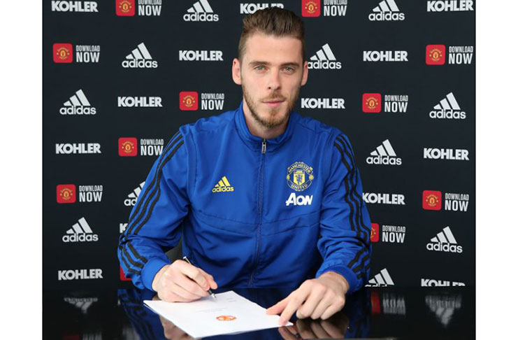 David de Gea of Manchester United poses after signing a new contract with the club. (Photo by John Peters/Manchester United via Getty Images)