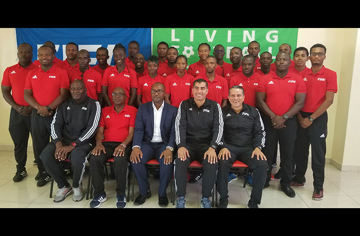 FIFA Technical Instructors, Javier Santos, Jeffrey Stolis, and Fitness Instructor Alan Brown flanked by GFF officials and participants of the FIFA RAP in Guyana.