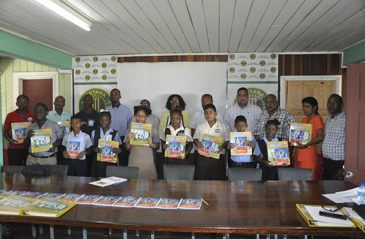 Students and the various officials with the manuals that will be soon be in the classroom. 