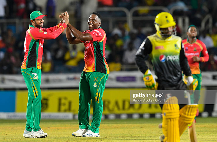 Shoaib Malik (L) and Odean Smith (C) of Guyana Amazon Warriors celebrate the dismissal of Zahir Khan (R) of Jamaica Tallawahs during Match 15 of the Hero CPL between Tallawahs and Warriors at Sabina Park on September 18, 2019 in Kingston, Jamaica. (Photo by Randy Brooks - CPL T20/Getty Images)