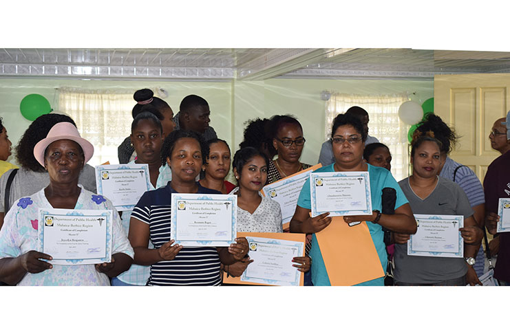 Some of the new food handlers with their certificates during the recent handing over exercise
