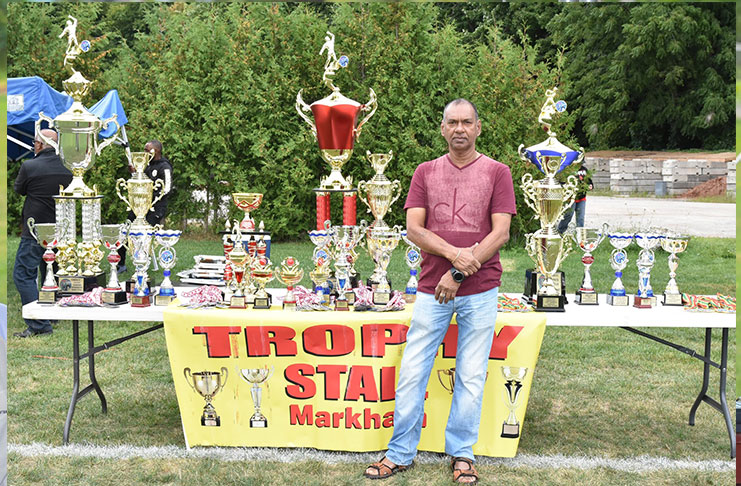 Ramesh Sunich poses with his collection of trophies at the Toronto Cup final, held at the University of Toronto ground recently.